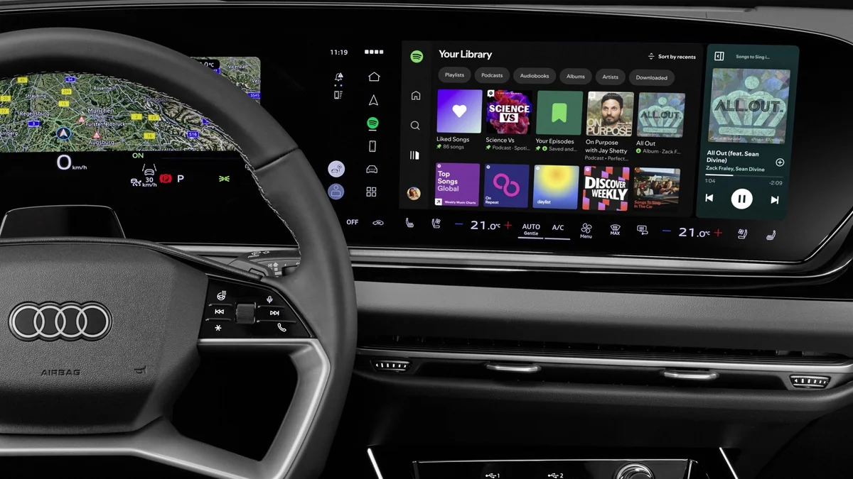 Cockpit van een Audi met de Spotify-app op het middelste scherm en de digitale tellers